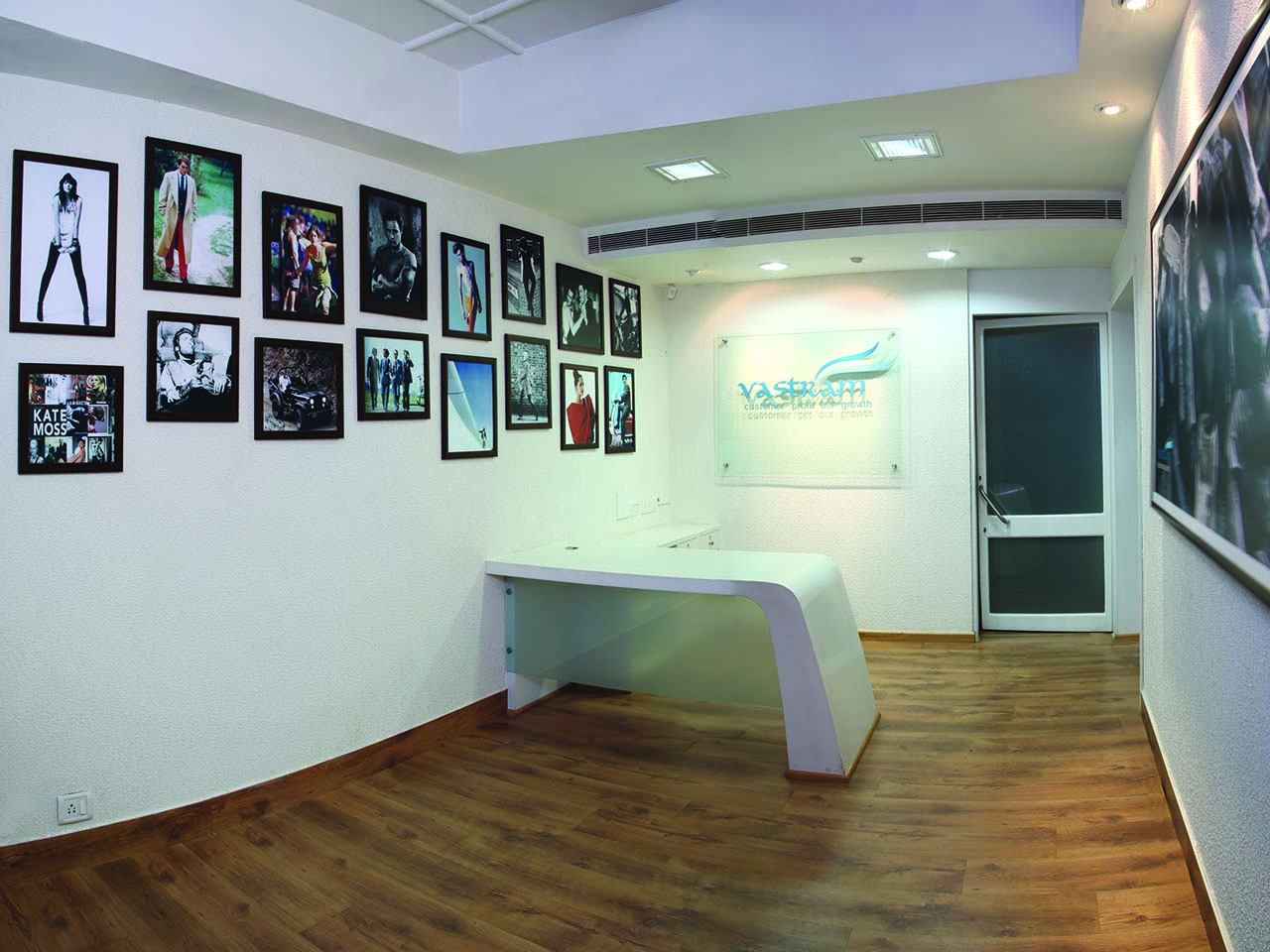 Reception at the Vastram Office with various photos on the wall
